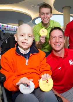 Professional disc golfers Will Schusterick (middle) and Paul Ulibarri (right) spend time with St. Jude Children's Hospital patient Luke. Photo courtesy of Biomedical Communications